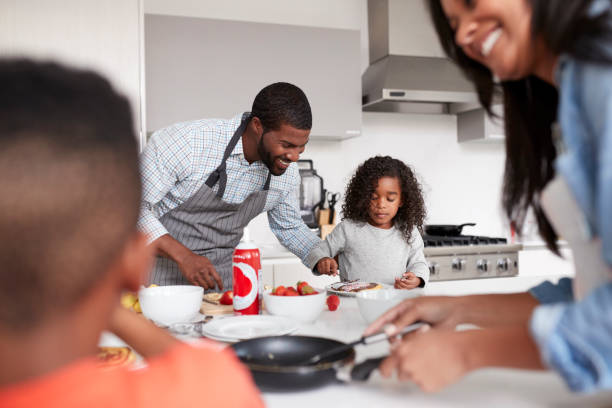 istock Family In Kitchen At Home Making Pancakes Together 1132958201