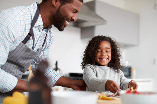 istock Father And Daughter In Kitchen At Home Making Pancakes Together 1132958271