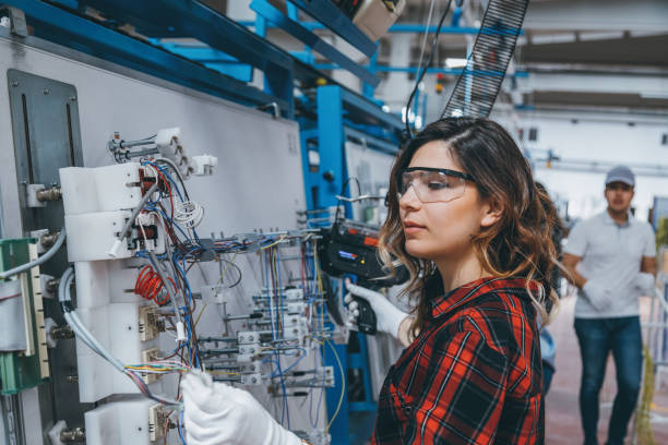 istock Female industrial worker using cable tie tool at factory 1132960501