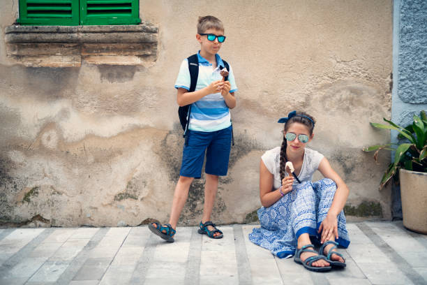 istock Kids tourists eating ice cream 1132961628