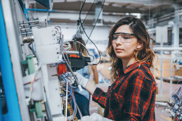 istock Female industrial worker using cable tie tool at factory 1132962717