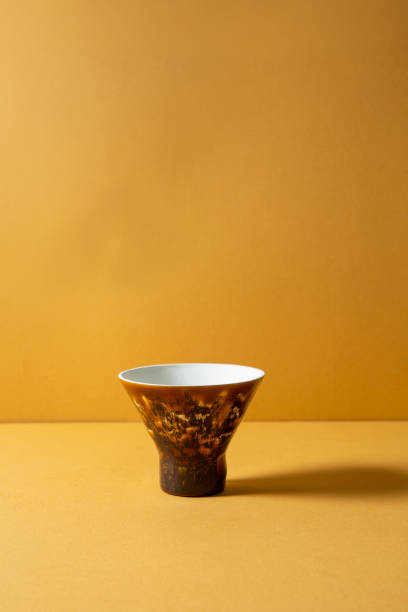 istock colorful cups on yellow background 1132963778