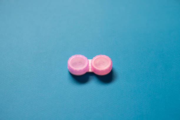 istock Pink contact lens cases on blue background 1132963796