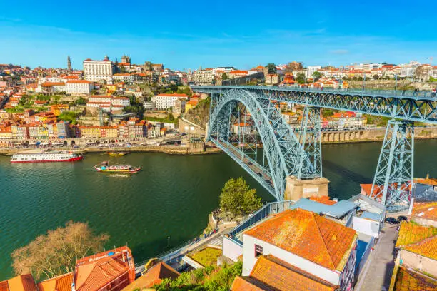 Cityscape of Porto (Oporto). View of the Dom Luis I Bridge (Ponte de Dom Luís I) and the River Douro. View from Vila Nova De Gaia, Portugal.