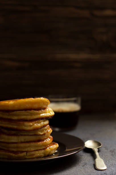 istock pancakes with honey and nuts, a cup of coffee, breakfast, dark background 1132968272
