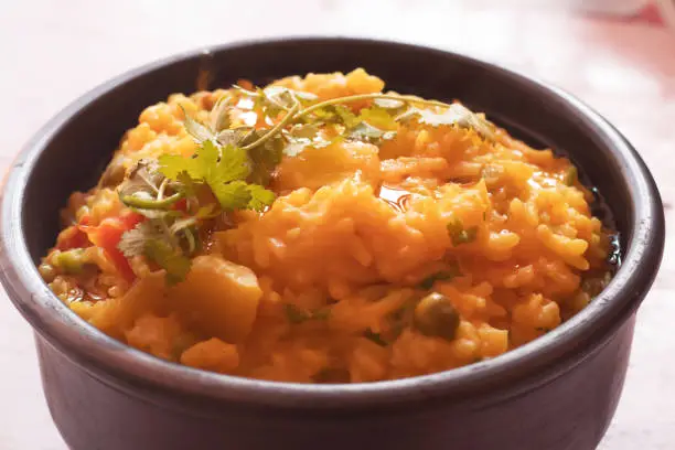 Indian traditional receipe khichdi made up of rice and lentil with Ghee over it