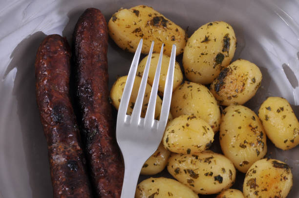 Potatoes and merguez on a plate meal based on merguez and potatoes in close-up grillade stock pictures, royalty-free photos & images