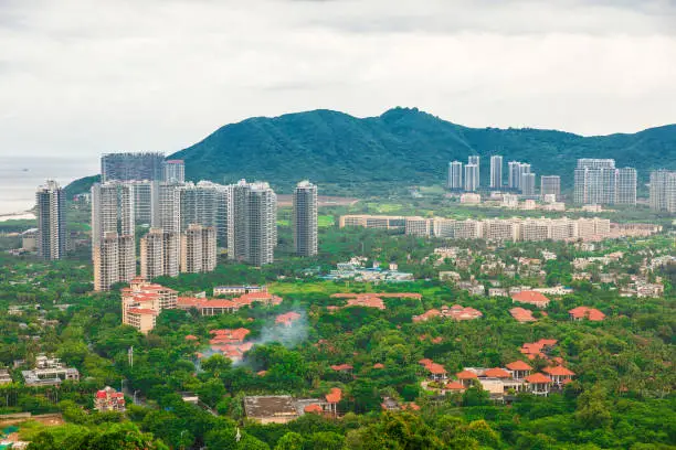 Photo of Beautiful Panoramic view of the resort city, China, Hainan. Town Sanya is popular tourist destination in China. Residential area of city Sanya, ashore South China Sea