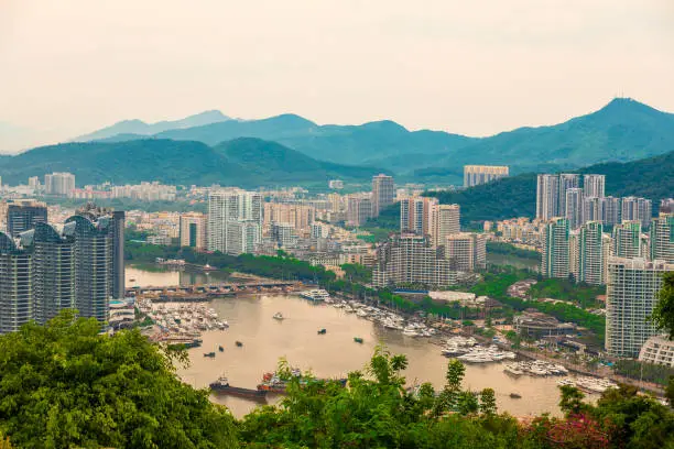 Photo of Beautiful Panoramic view of the resort city, China, Hainan. Town Sanya is popular tourist destination in China. Residential area of city Sanya, ashore South China Sea