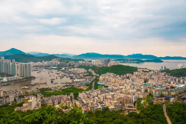 Photo of Beautiful Panoramic view of the resort city, China, Hainan. Town Sanya is popular tourist destination in China. Residential area of city Sanya, ashore South China Sea