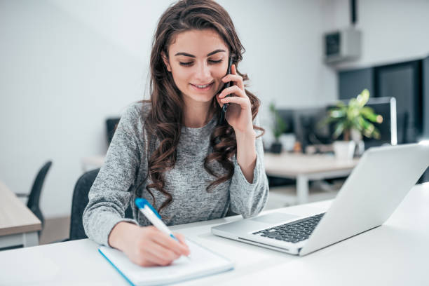 istock Girl talking on the phone and taking note. 1132973743