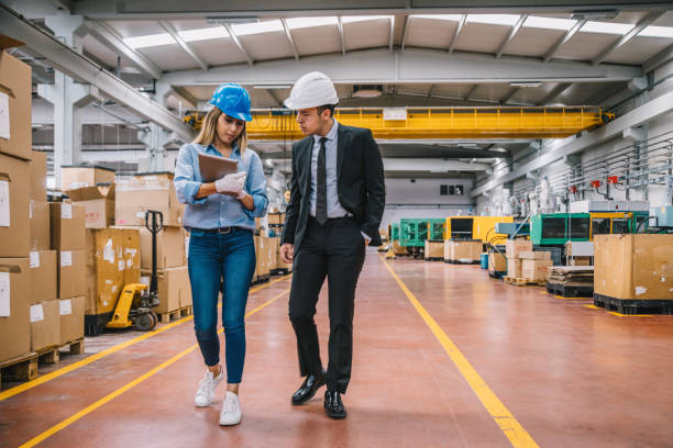 Business colleagues working with tablet computer in factory