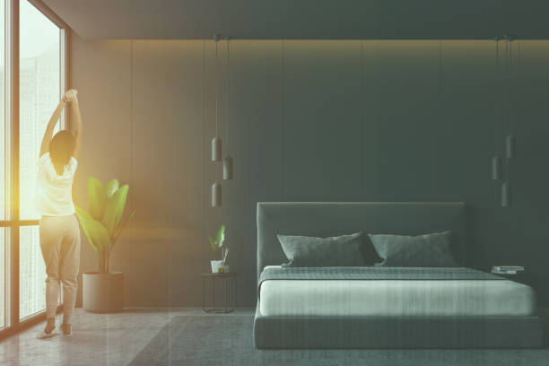 istock Gray panoramic bedroom interior, woman 1132975411