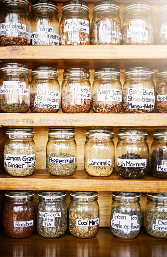 Shot of jars of various teas packed on shelves