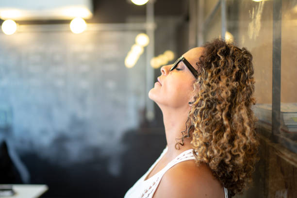 Frustrated latinx woman feeling loser standing at the office I am so tired banging your head against a wall photos stock pictures, royalty-free photos & images