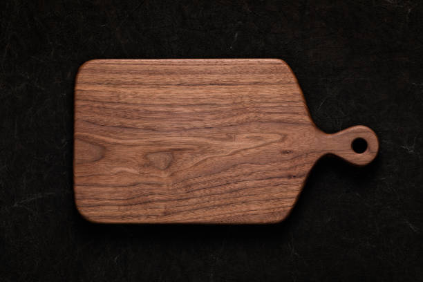 istock Handmade walnut chopping board on handmade tie dyed burlap 1132977682