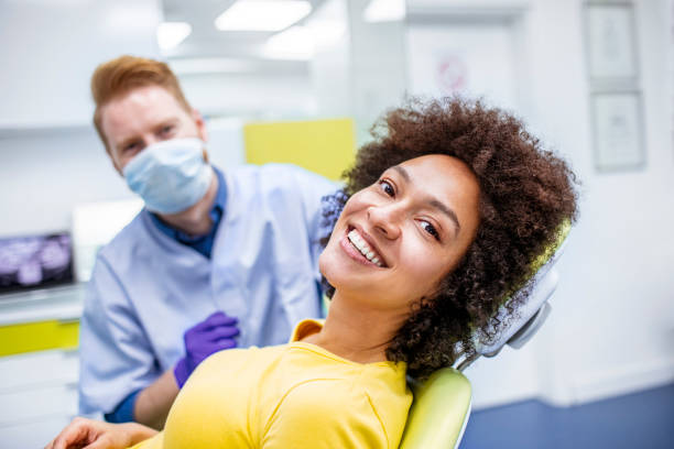 woman smiling during dental checkup - human teeth whitening dentist smiling imagens e fotografias de stock