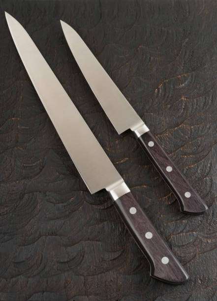 istock Two kitchen knives on black wooden board 1132978758