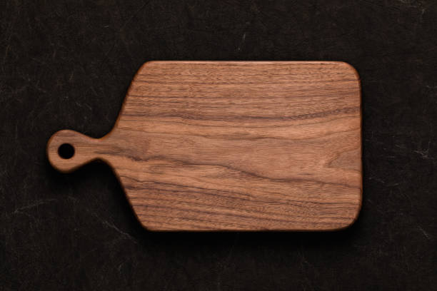 istock Handmade walnut chopping board on handmade tie dyed burlap 1132979154