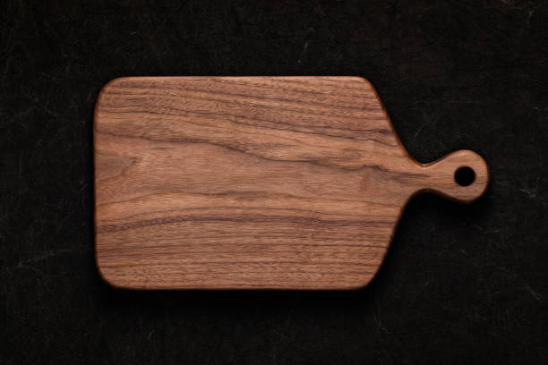 istock Handmade walnut chopping board on handmade tie dyed burlap 1132980172
