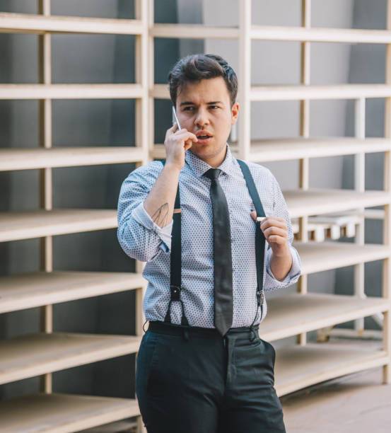 istock Young businessman using a smartphone in warehouse 1132980353