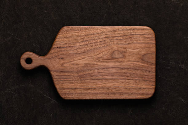 istock Handmade walnut chopping board on handmade tie dyed burlap 1132980610