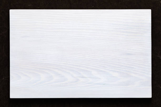 istock White wooden board on hand smeared burlap 1132980780