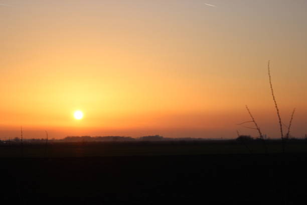 istock Sunset over a country road 1132981221