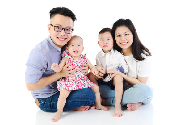 Young happy Asian family at home