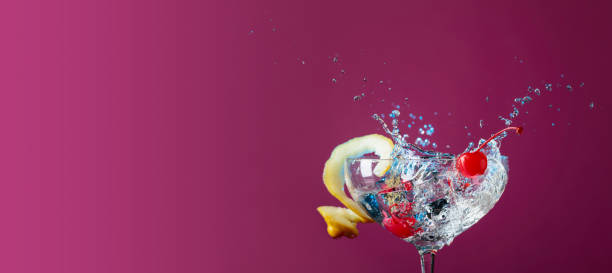 istock Cocktail in glass with splashes garnished with lemon and cherries 1132984299