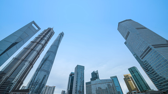 The pedestrian pavement under the tall building large building.