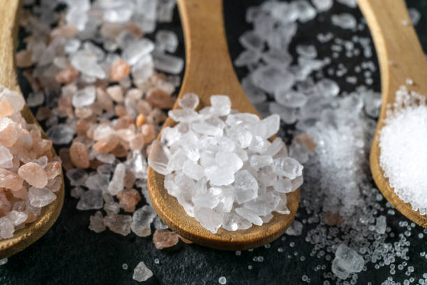 istock Different types of salt. Top view on three wooden spoons 1132984913