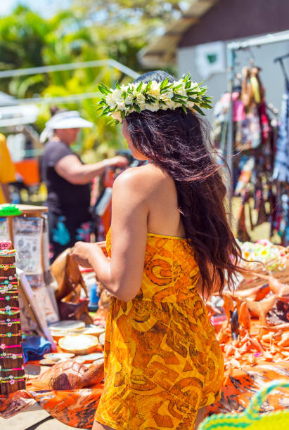 Girl with a white wreath of flowers, Rarotonga, Aitutaki, Cook Islands. With selective focus. Back view. Vertical stock photo