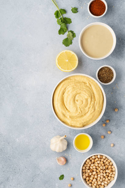 istock Bowl of hummus and ingredients for cooking. 1132986406