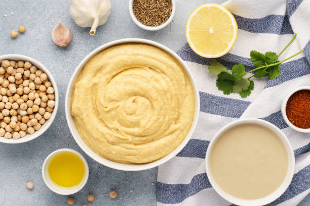 Hummus ingredients - chickpea, lemon, garlic, sesame, olive oil. Hummus ingredients for cooking - chickpea, tahini, olive oil and herbs. Middle eastern cuisine. Top view. hummus stock pictures, royalty-free photos & images