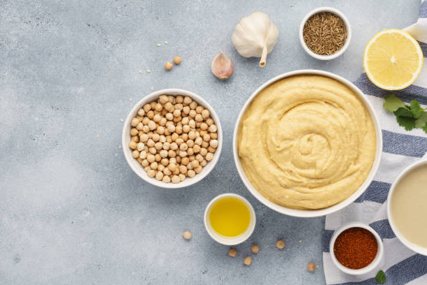 istock Bowl of hummus and ingredients for cooking. 1132986520