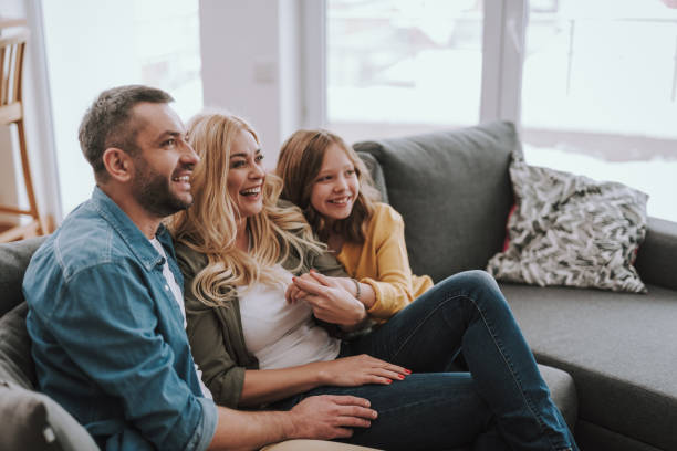 istock Happy family resting on comfortable couch at home 1132987171