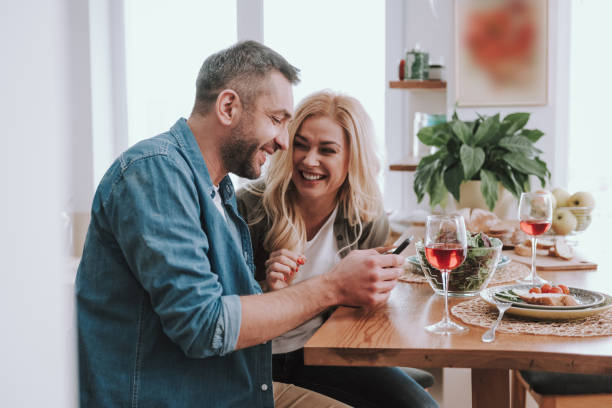 istock Handsome bearded man with cellphone having dinner with his charming wife 1132987265