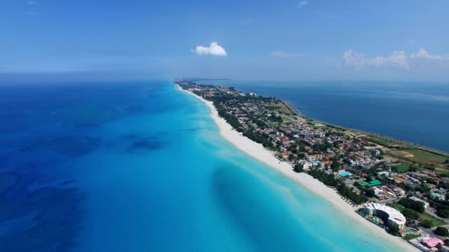 Drone is flying at tropical island in the Atlantic Ocean. Bird's-eye view to main streets, houses and coastline of Varadero.
