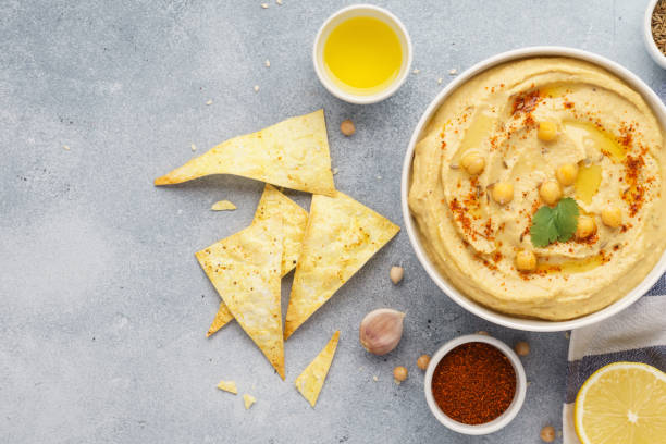 istock Hummus bowl served with tortilla chips. Middle eastern food. 1132987807