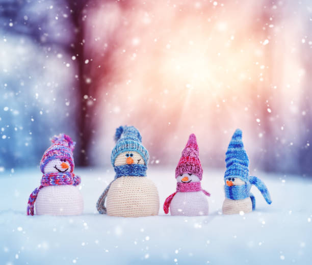 istock little snowmans on soft snow on blue background 1132989075