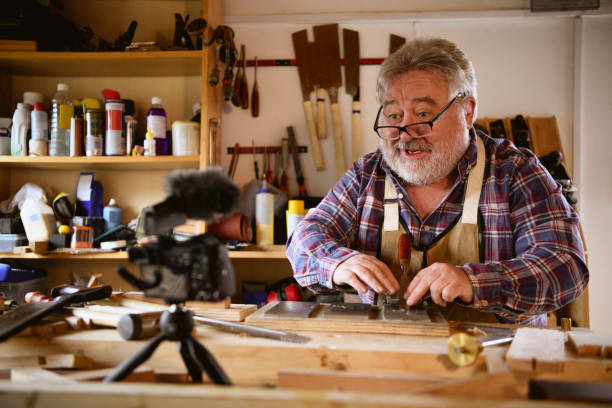 istock Candid portrait of mature carpenter vlogging 1132989100