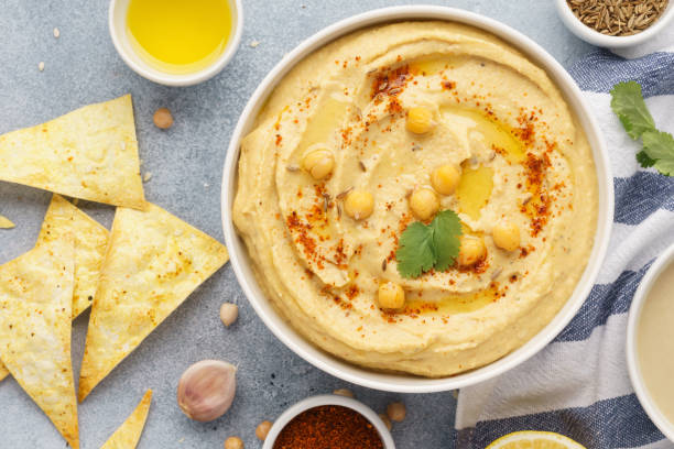 istock Hummus bowl served with tortilla chips. Middle eastern food. 1132989415