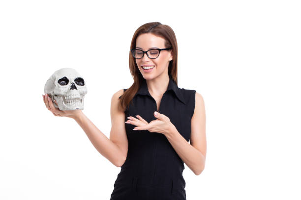 istock Young businesswoman talking with skull 1132990055