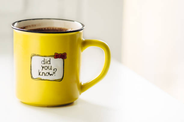 Yellow mug with coffee . With an inscription. Did you know?