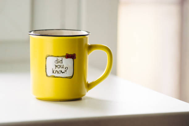 istock Yellow mug with coffee . With an inscription. Did you know? 1132990280