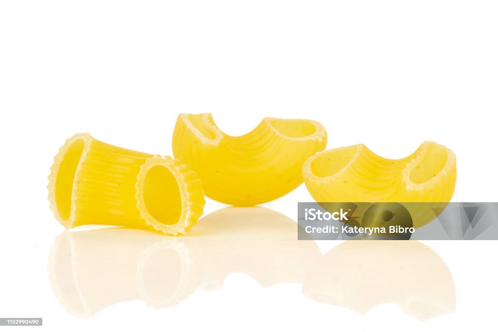 Raw pasta pipe rigate isolated on white Group of three whole raw pasta pipe rigate variety isolated on white background Bright Stock Photo