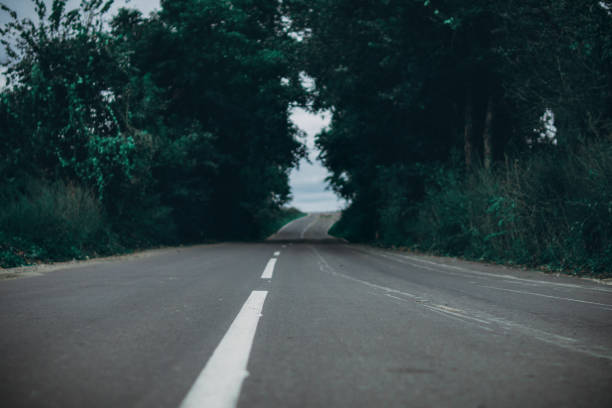 istock cloudy dark country road 1132990896