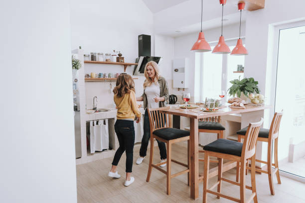 istock Cheerful mother and daughter having fun at kitchen 1132990980