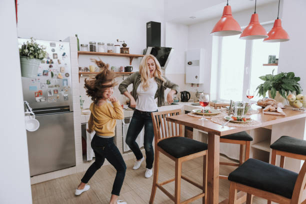 Cheerful mother and daughter having fun at home